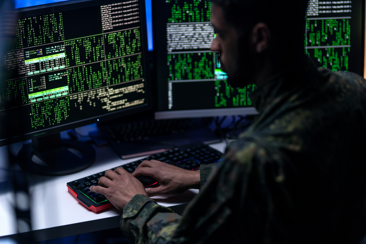 A Cybersecurity Military Professional Working on a Monitor