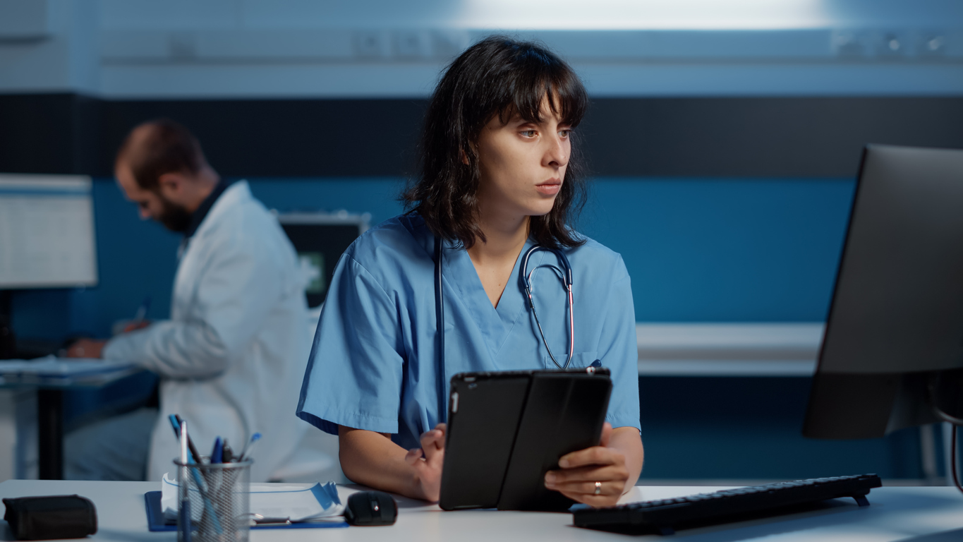 Nursing Curriculum Developer Using a Tablet and a Computer.