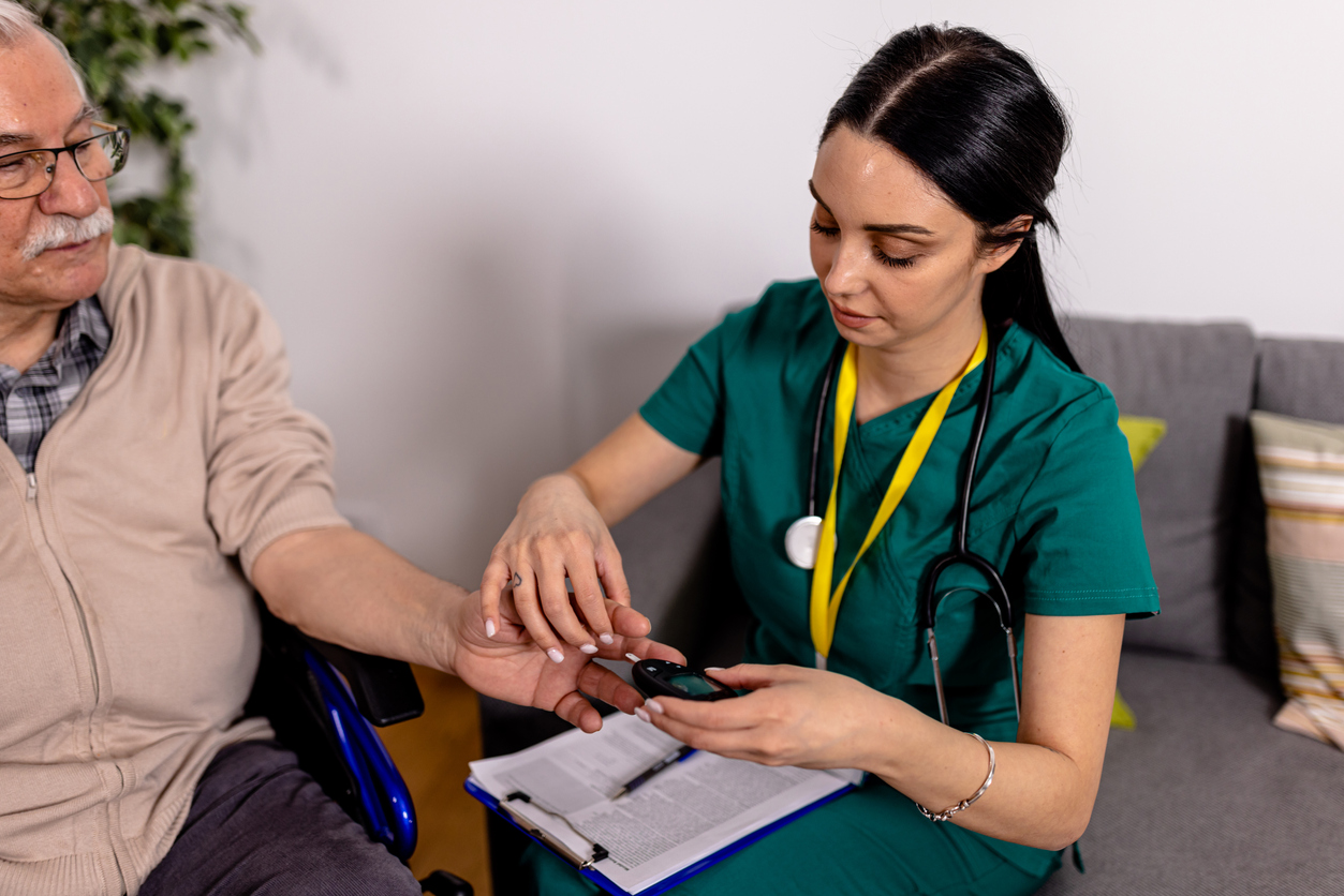 An adult gerontology acute care nurse practitioner with a patient in a medical facility.