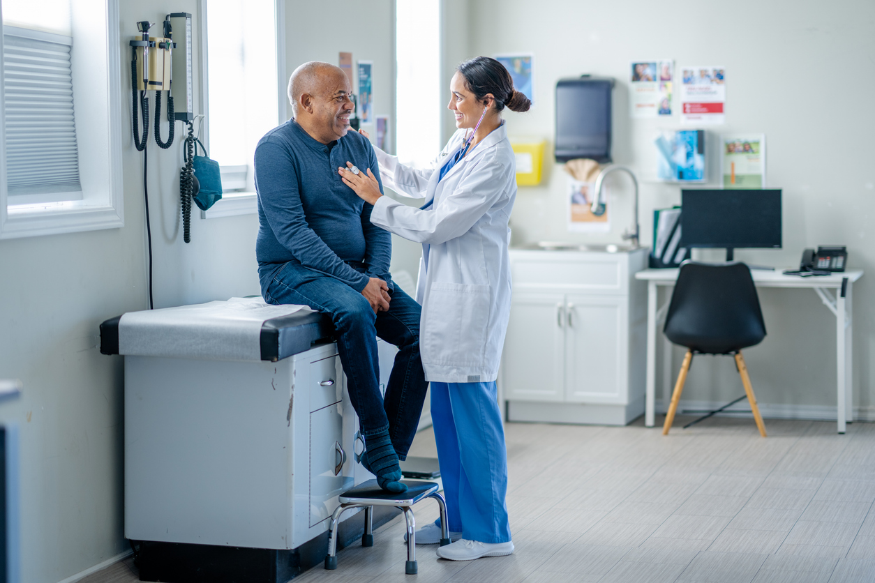 A Nurse Practitioner Wearing a White Coat Conducts a Physical on a Patient..jpg