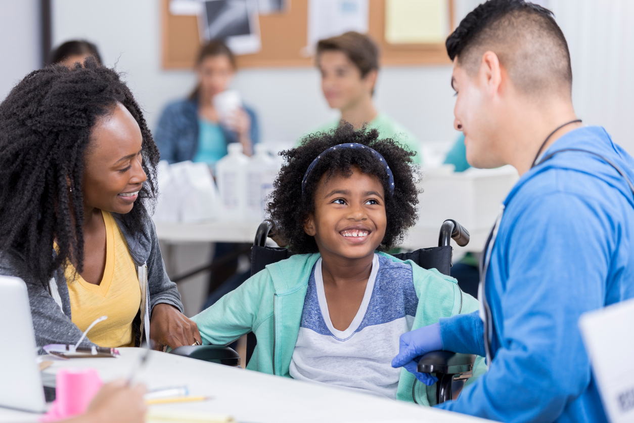 A Community Health Nurse Talks With a Young Patient and Their Parent.