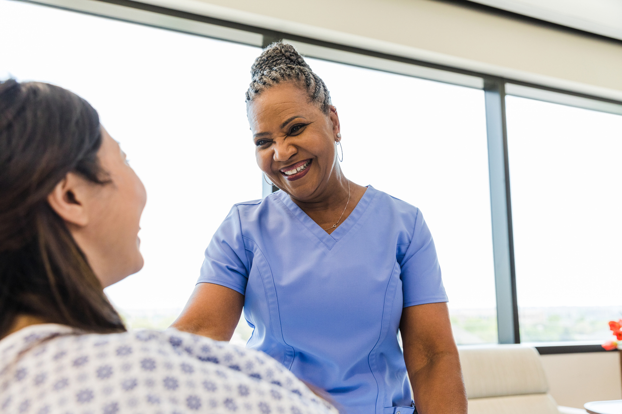 Nurse Speaking to a Patient in a Medical Facility.