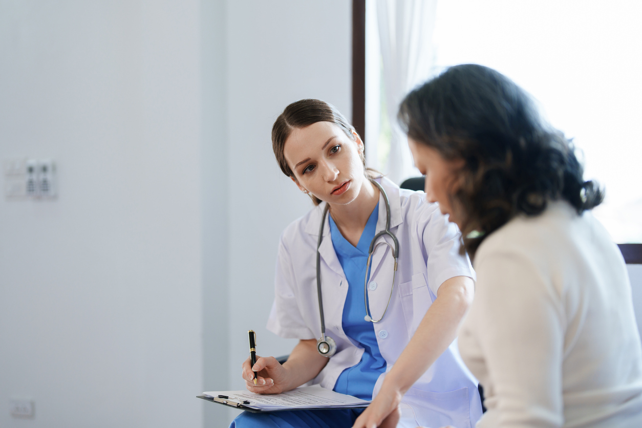 A Nurse Talks With a Patient.